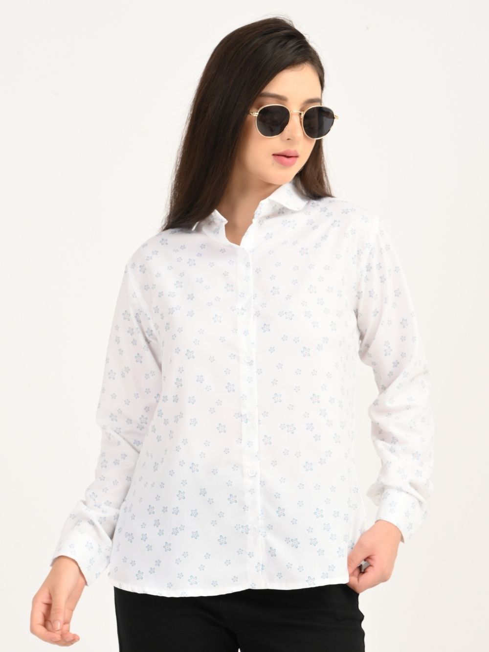 Woman wearing Petal Charm white shirt with blue floral print, front view
