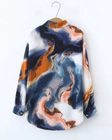 Colorful patterned shirt on a hanger against a white background