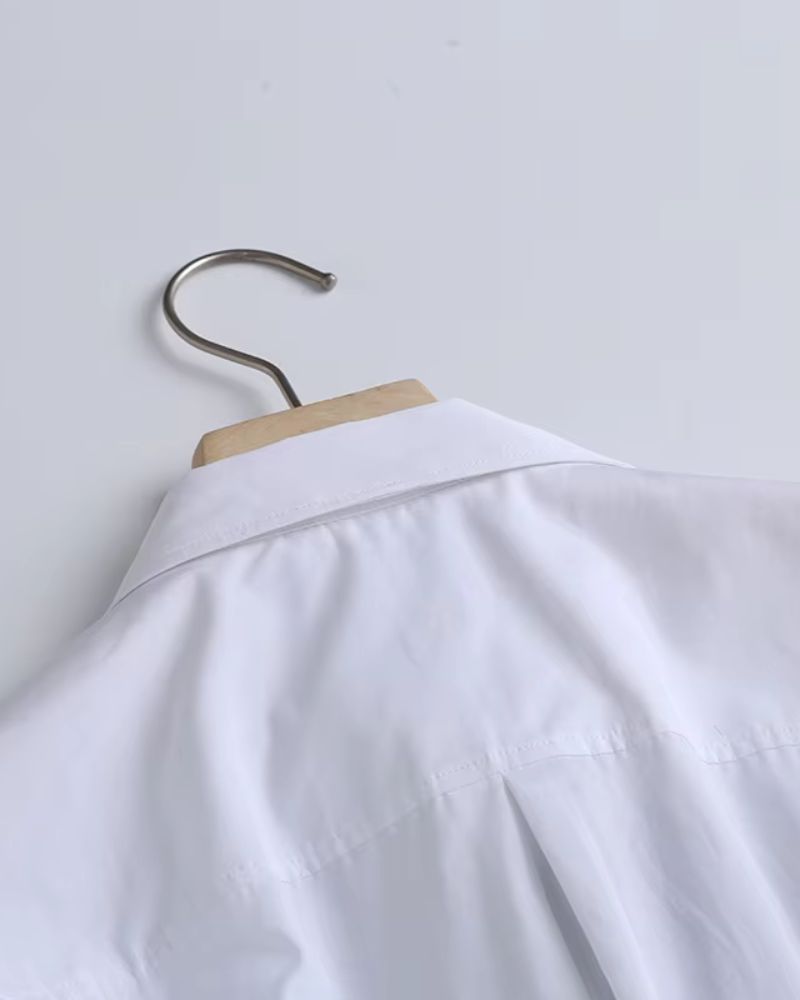 Back collar detail of premium white rayon women's shirt on hanger

