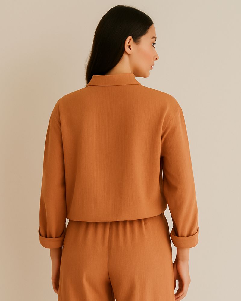Back view of relaxed crinkle cotton shirt and pants in sunbaked clay color

