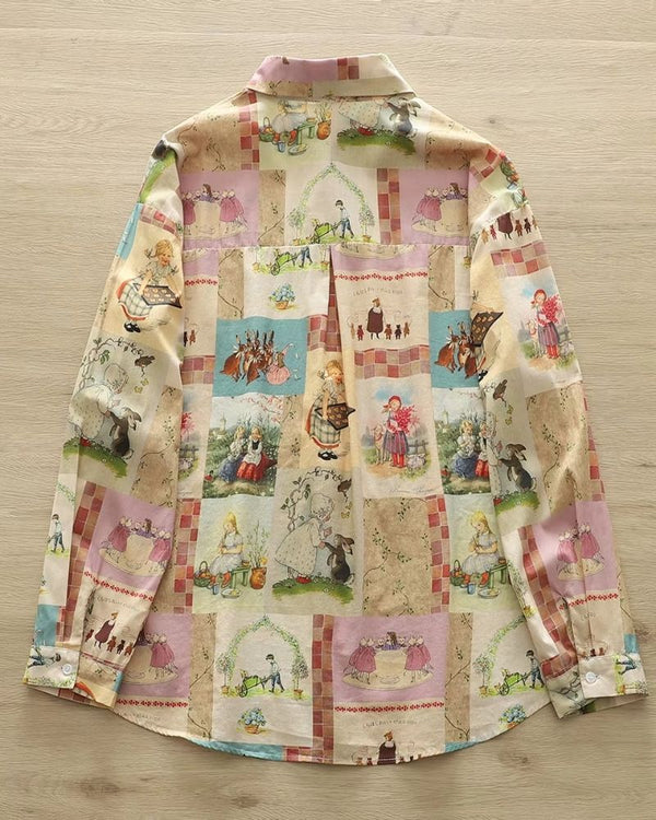 "Back of the Pennywhistle Meadow shirt featuring fairytale scenes"

