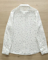 Back view of Celeste Bloom rayon shirt for women featuring delicate blue floral pattern on breathable off-white fabric

