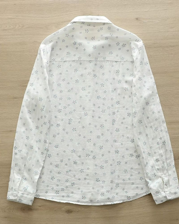 Back view of Celeste Bloom rayon shirt for women featuring delicate blue floral pattern on breathable off-white fabric

