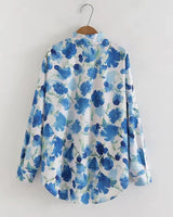 "Back view of women’s Meadow Song in Blue rayon shirt showcasing flowy fit and botanical print."

