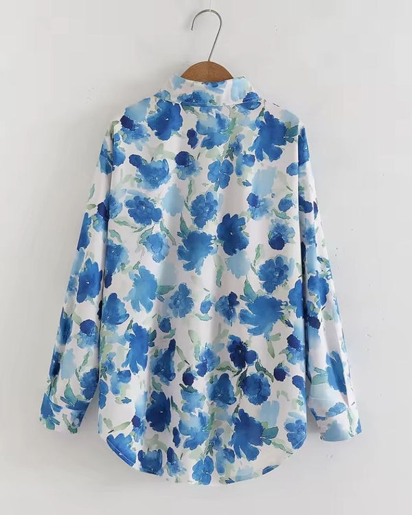 "Back view of women’s Meadow Song in Blue rayon shirt showcasing flowy fit and botanical print."


