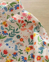 Close-up of La Lune Botanique rayon shirt featuring colorful botanical and unicorn print on soft fabric

