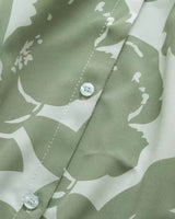 Close-up of Verde Amour women's green floral rayon shirt with white buttons

