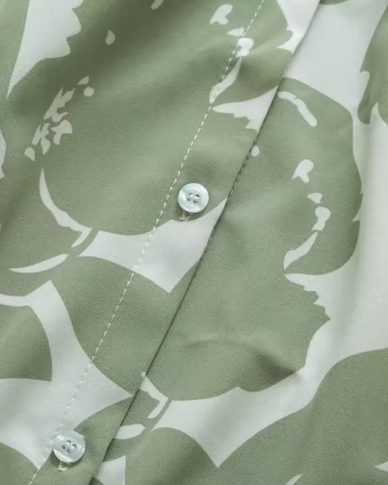 Close-up of Verde Amour women's green floral rayon shirt with white buttons

