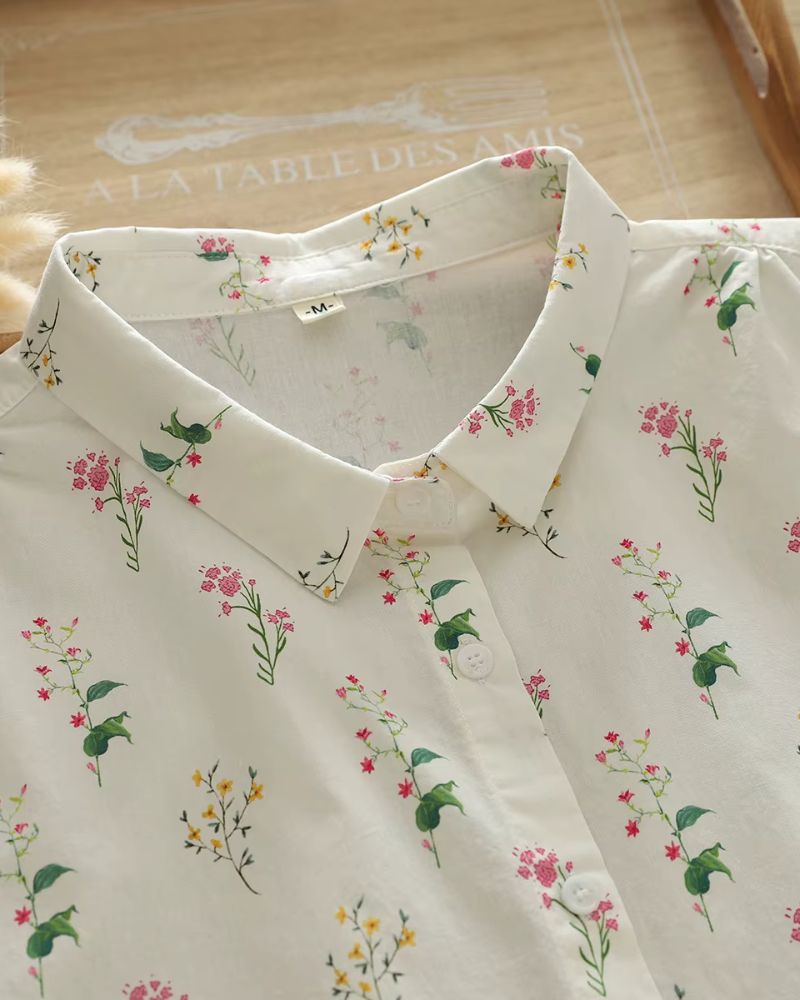 Close-up of collar and top buttons on ivory rayon floral shirt for women, highlighting print and stitching detail

