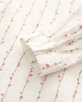 Close-up of shirt’s side seam and soft floral vine detailing on rayon

