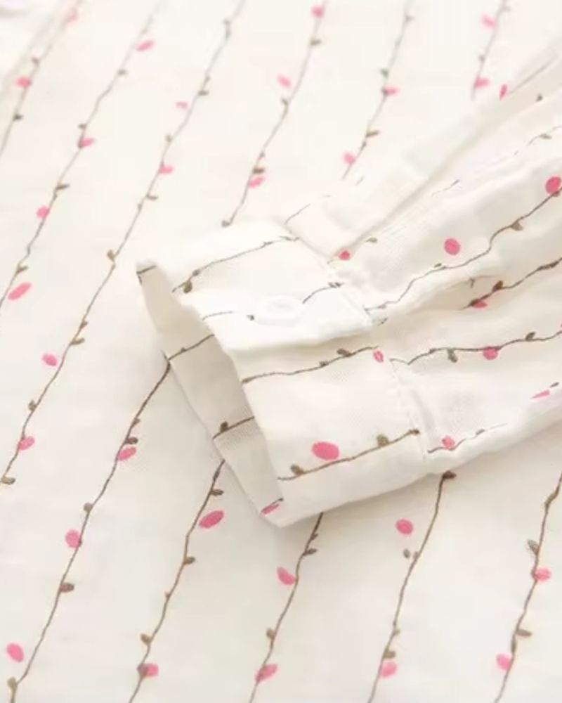 Close-up of shirt’s side seam and soft floral vine detailing on rayon

