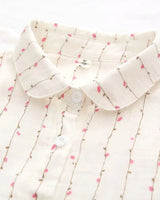 Close-up of soft point collar and button placket on floral rayon shirt

