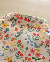 Detailed close-up of whimsical floral and unicorn design on La Lune Botanique shirt fabric

