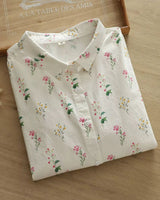 Folded women's rayon shirt with delicate floral pattern, showcasing lightweight fabric and collared design

