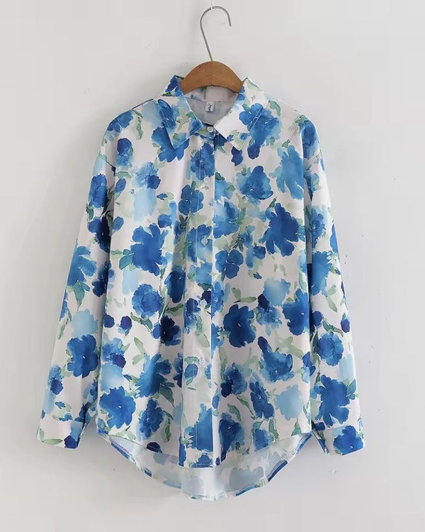 "Front view of Meadow Song in Blue women’s rayon shirt with long sleeves and watercolor floral pattern."


