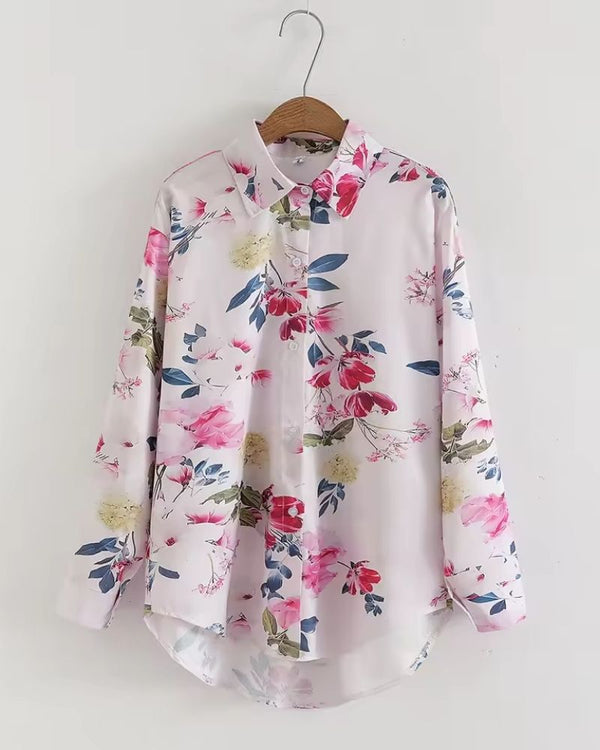 Front view of women's pink floral rayon shirt on hanger

