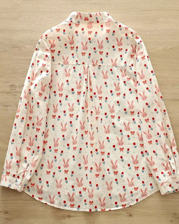 Lightweight women’s blouse with pink bunny, tulip, and bow print on white background

