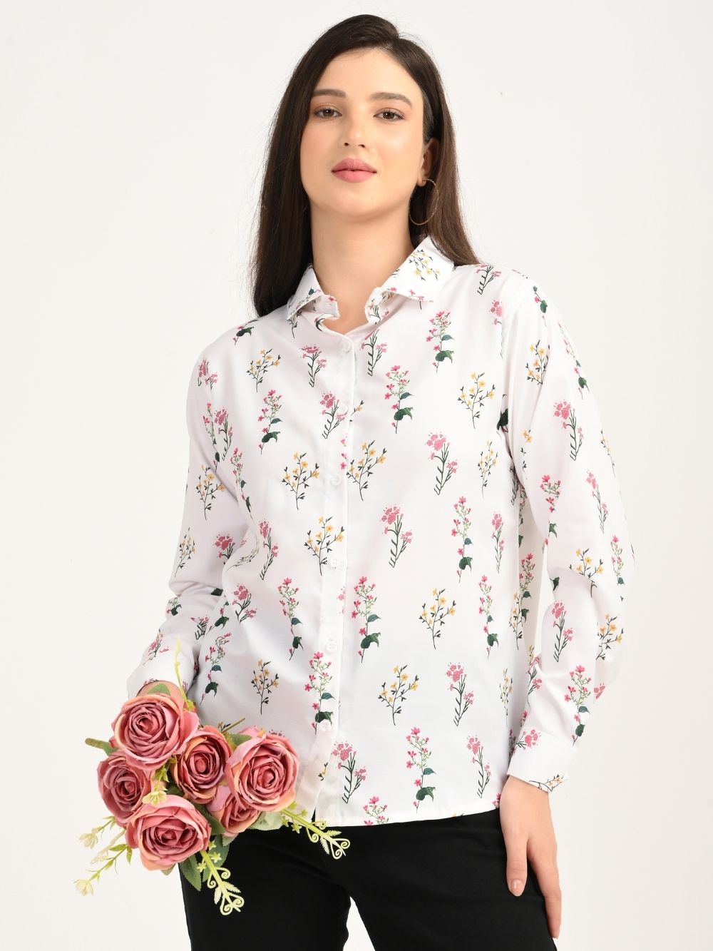 Model in floral shirt holding pink roses