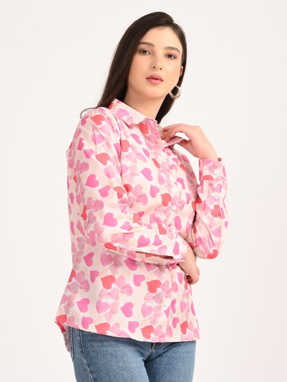 Side pose in pink heart print button-down shirt