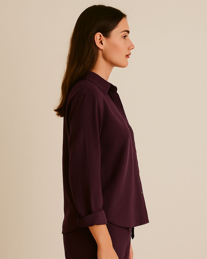 “Side view of relaxed fit crinkle cotton shirt in burgundy with cuffed sleeves”

