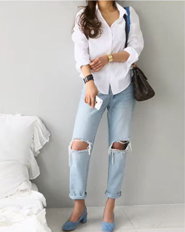 Tailored white rayon shirt styled with ripped jeans and blue block heels for casual chic look

