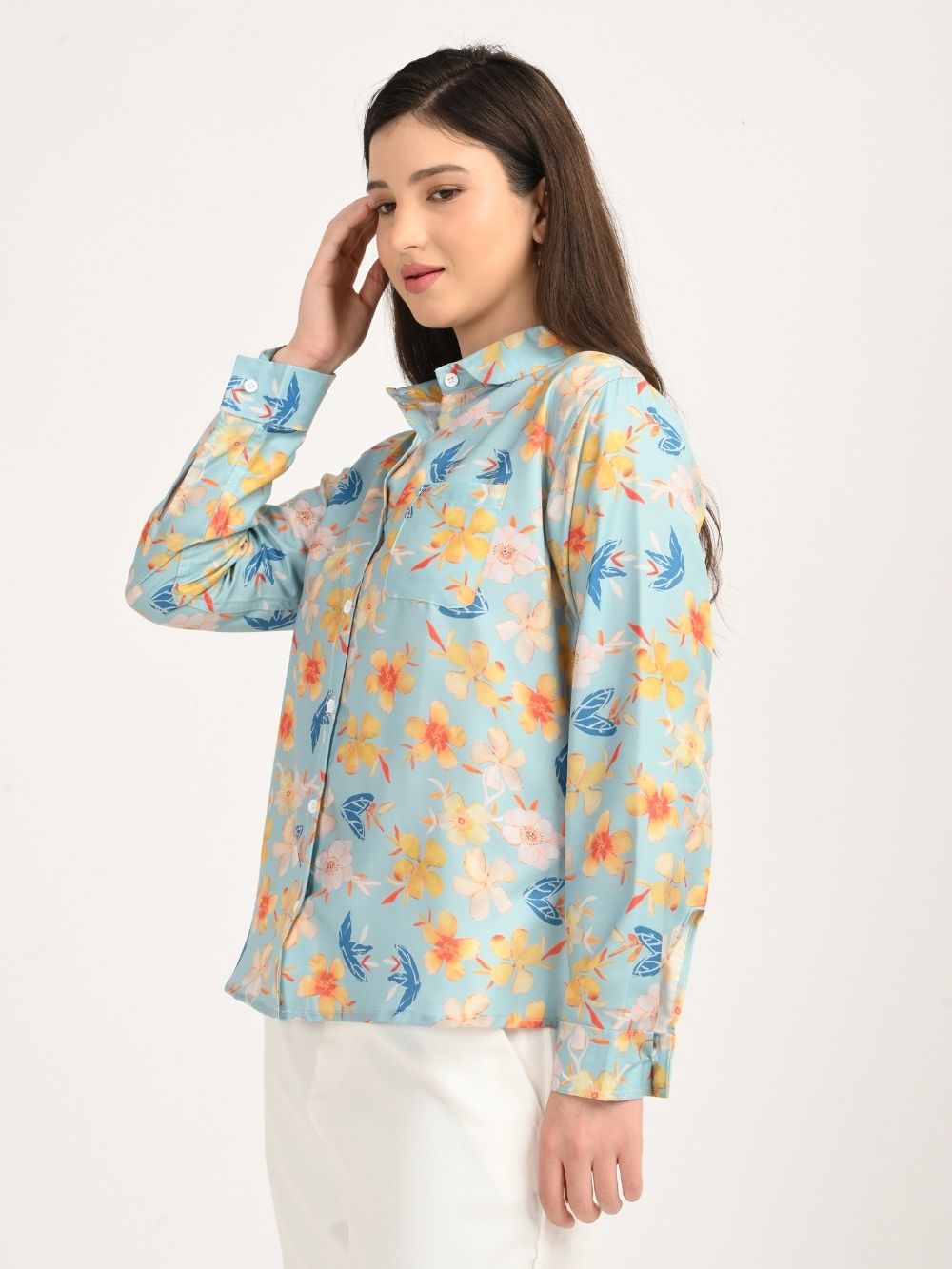 Woman in aqua blue floral shirt, side profile
