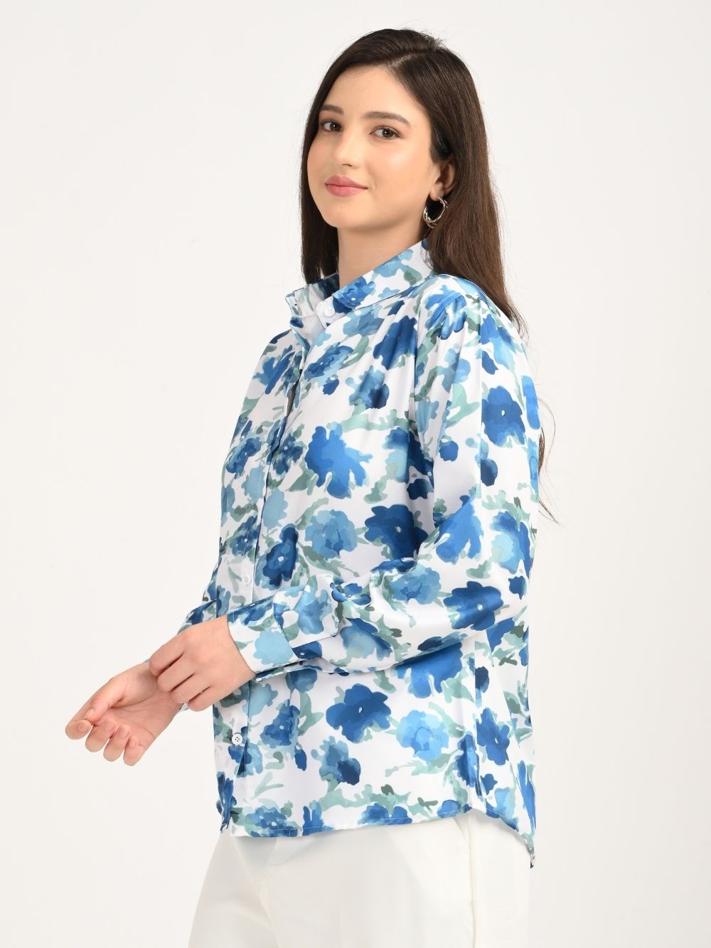 Woman in side pose wearing blue floral shirt