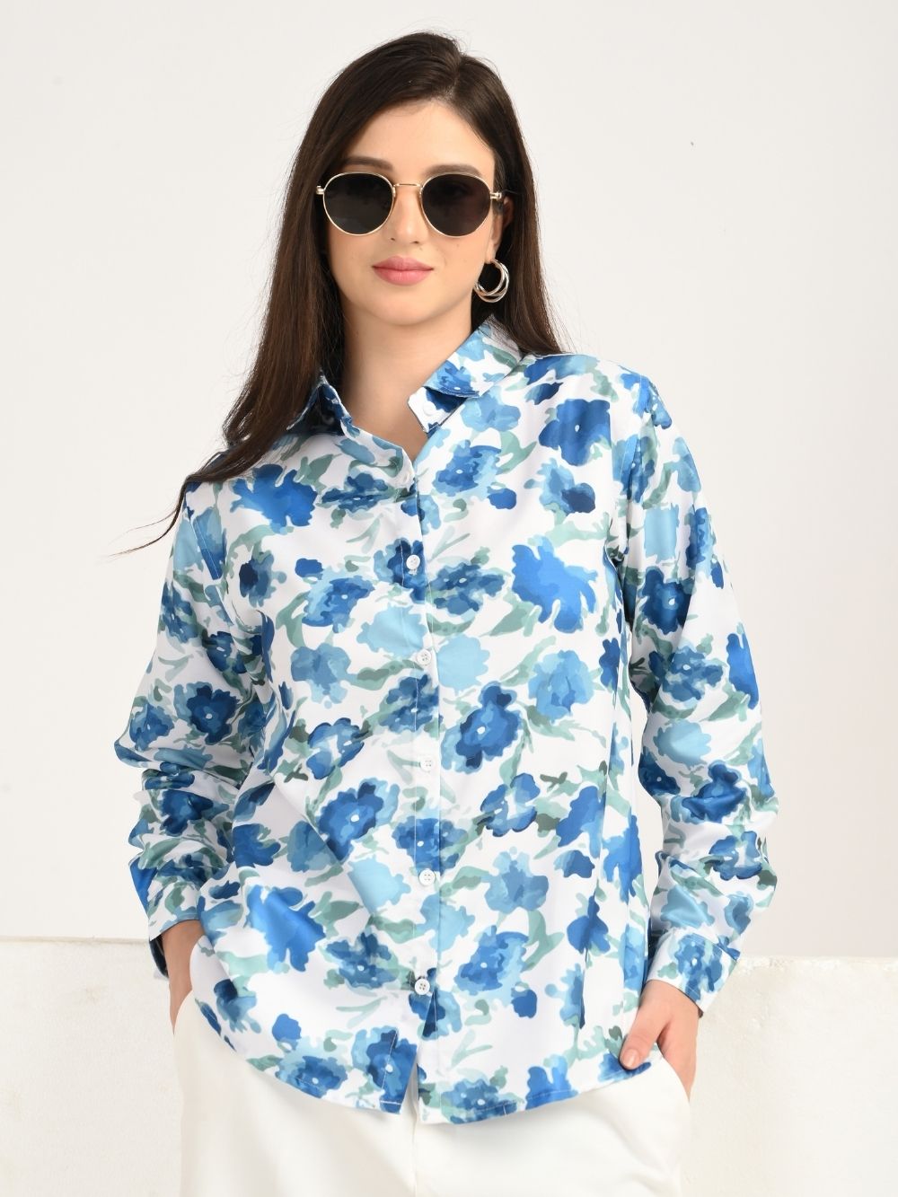 Woman in sunglasses wearing blue floral shirt