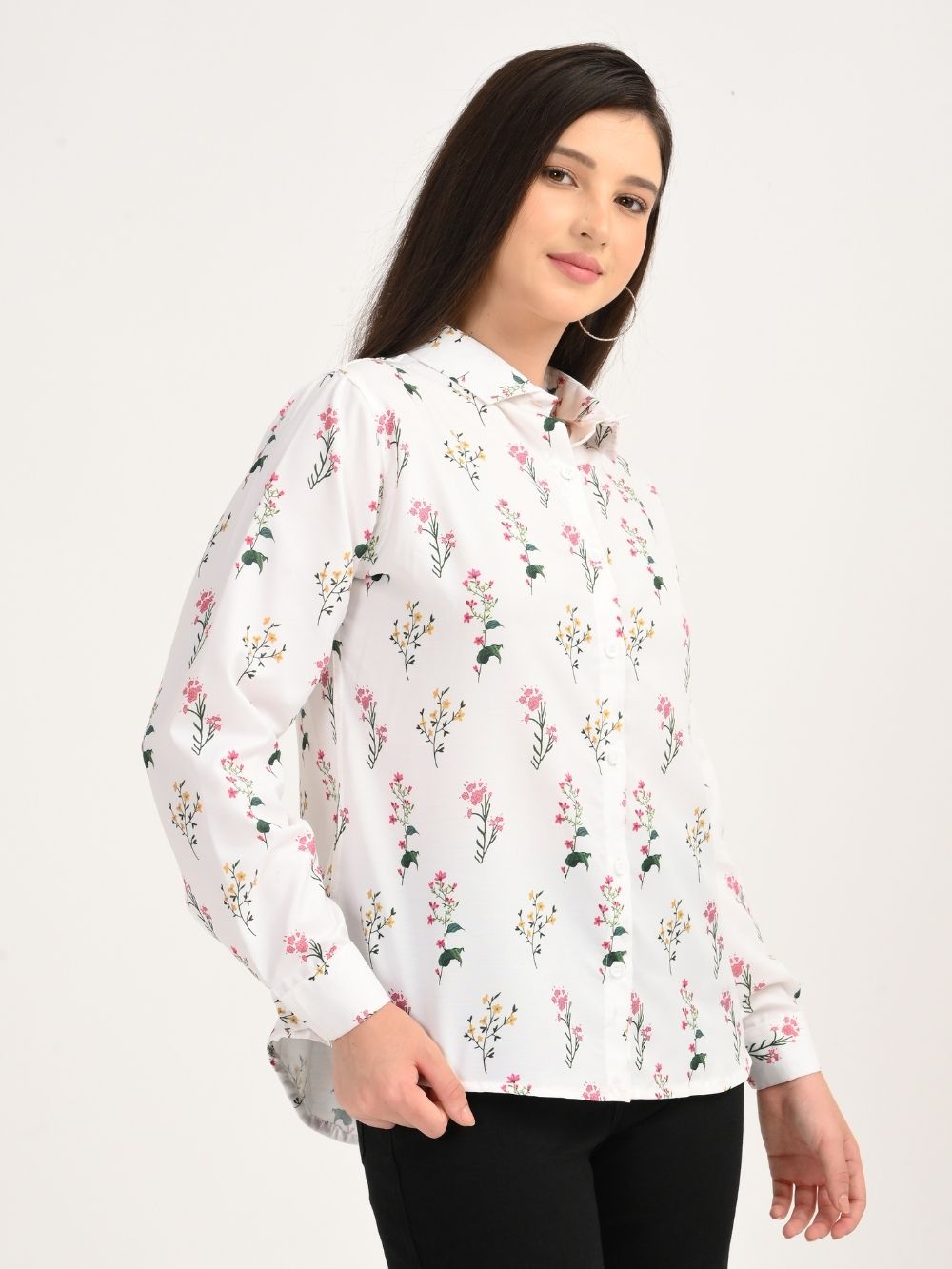 Woman in white floral print shirt side pose