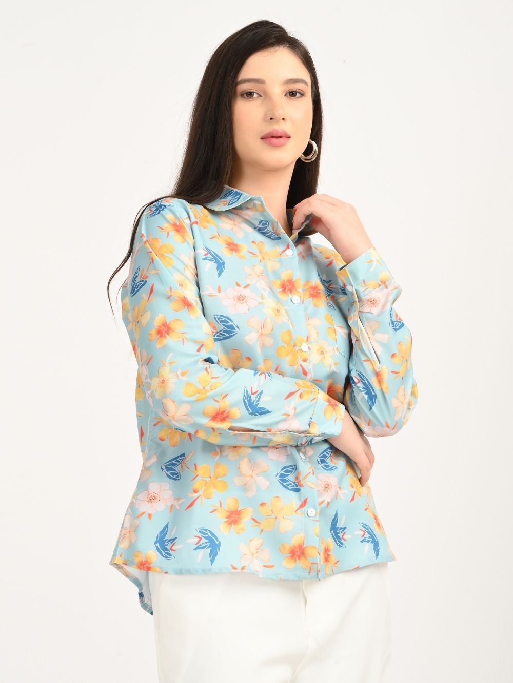 Woman posing in aqua blue floral print shirt, side front view