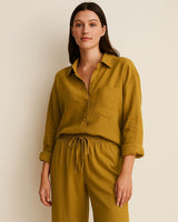 “Woman wearing mustard yellow cotton loungewear set – crinkle muslin shirt and pants, front view”

