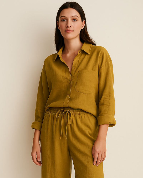“Woman wearing mustard yellow cotton loungewear set – crinkle muslin shirt and pants, front view”

