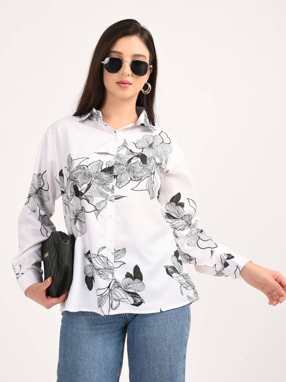 Woman wearing white shirt with black floral print, front view with sunglasses