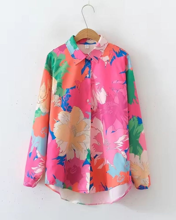 Colorful floral shirt on a hanger against a white background