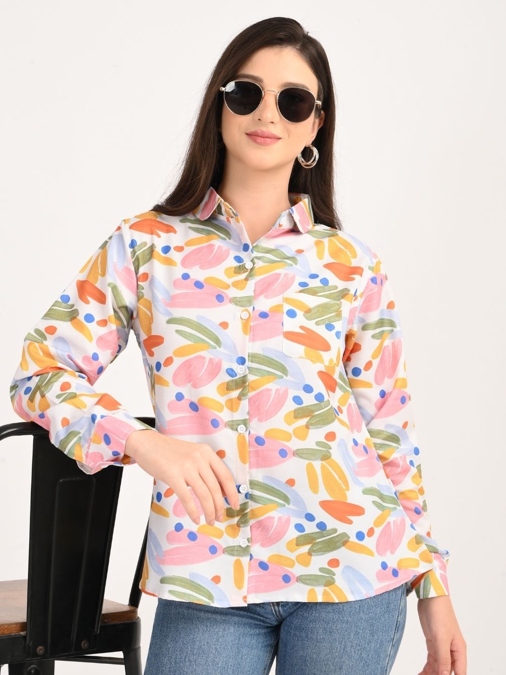 Front view of woman in colorful abstract shirt with sunglasses