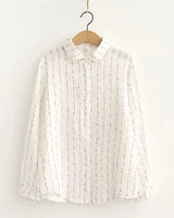 Front view of white rayon blouse with vertical pink vine print, long sleeves and collar


