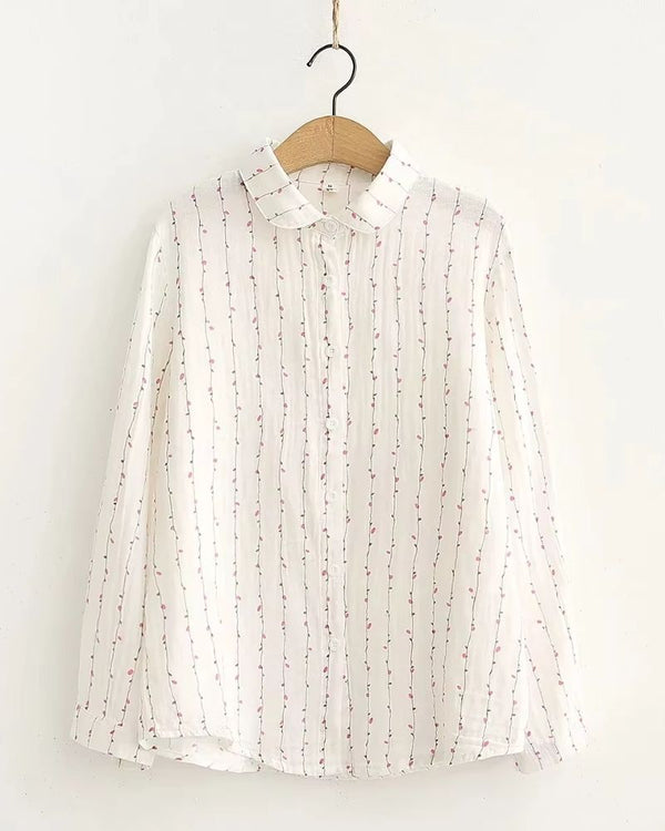 Front view of white rayon blouse with vertical pink vine print, long sleeves and collar


